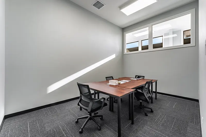 Suite 131: office with a meeting table and transom windows