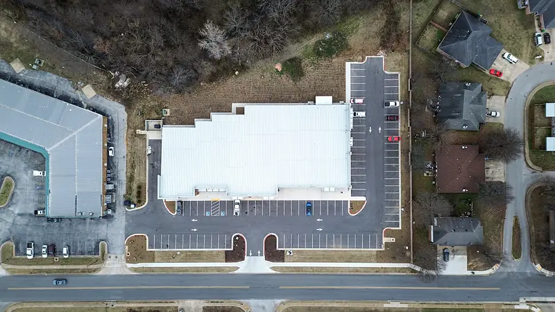 Overhead view of the building, front lot and side parking